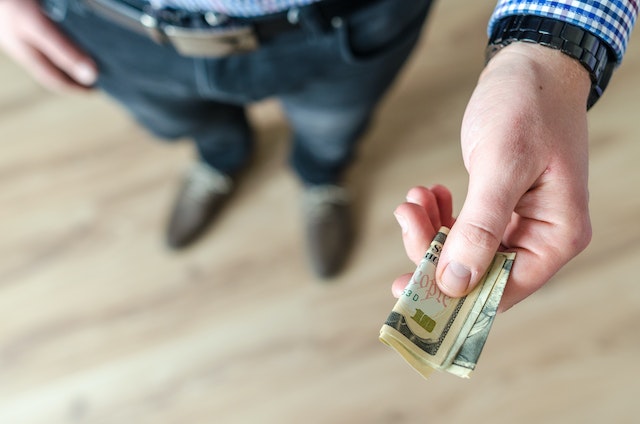 person handing over cash