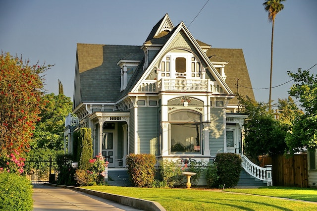 grey-white house surrounded by trees