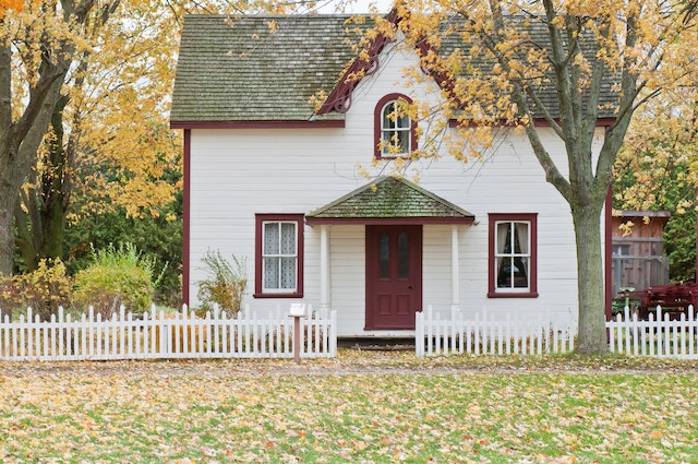 white house surrounded by trees in the fall