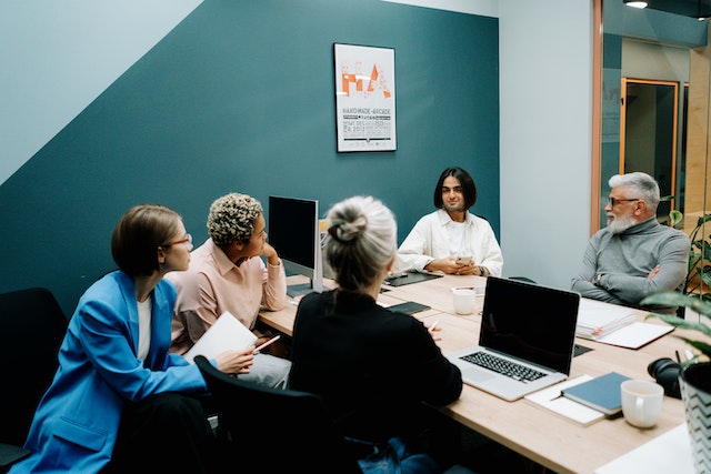 management team talking around a table