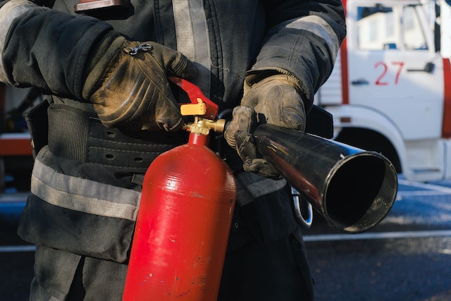 person holding fire extinguisher