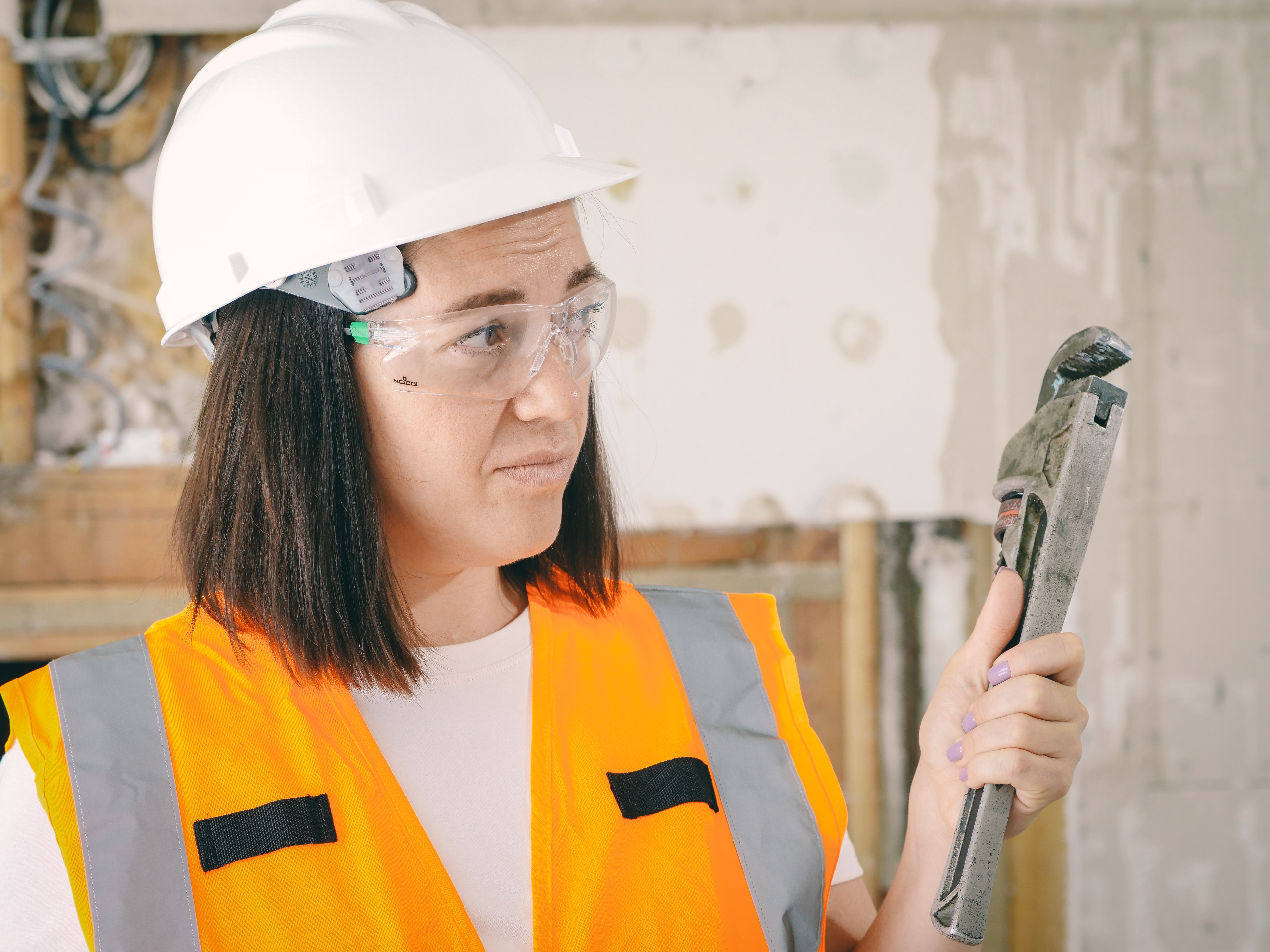 A plumber holding a wrench.