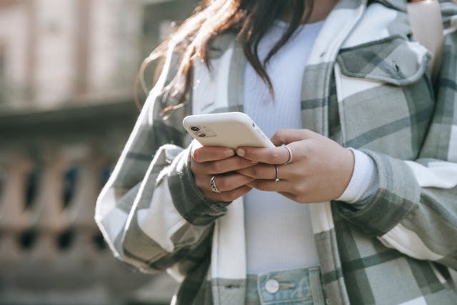 A person typing on a smartphone.